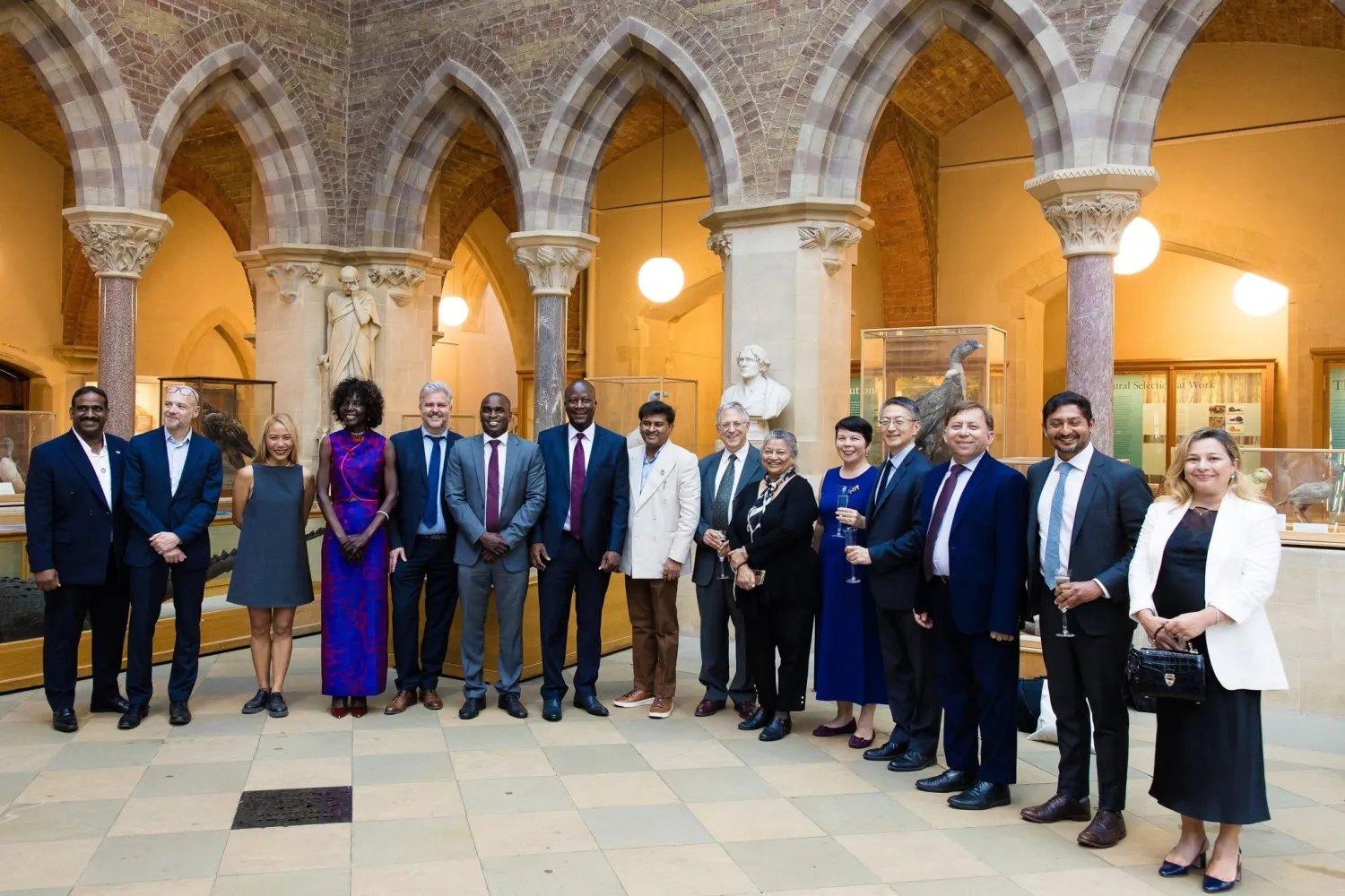 semi circle of 15 people facing the camera smiling