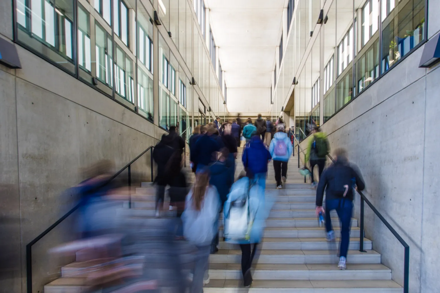 motion image of people walking up and down a flight of stairs