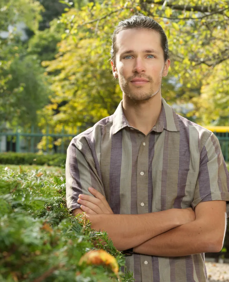 image of a man with crossed arms smiling at the camera