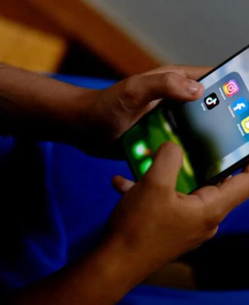 image of a pair of hands holding a mobile screen